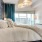 a bed with a large mirror and a chandelier