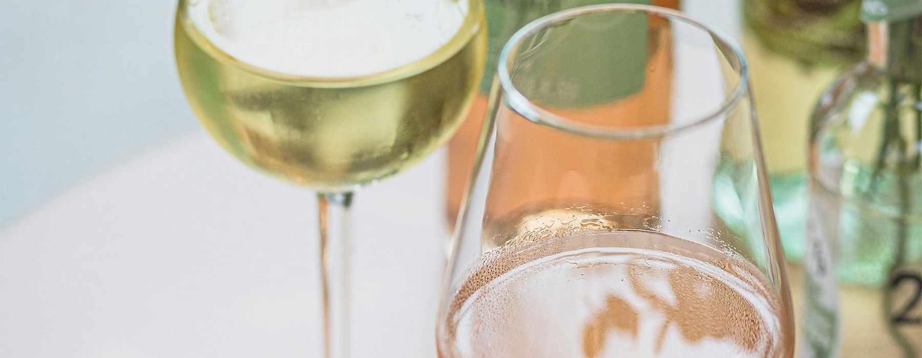 a bottle of wine next to a glass of wine