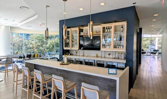 a community kitchen with a bar and chairs