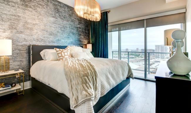 a bedroom with a bed and a large window